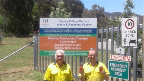 Site supervisor  Rick and recycling worker Geoff in front fo the new Tumut site access hours sign.jpg